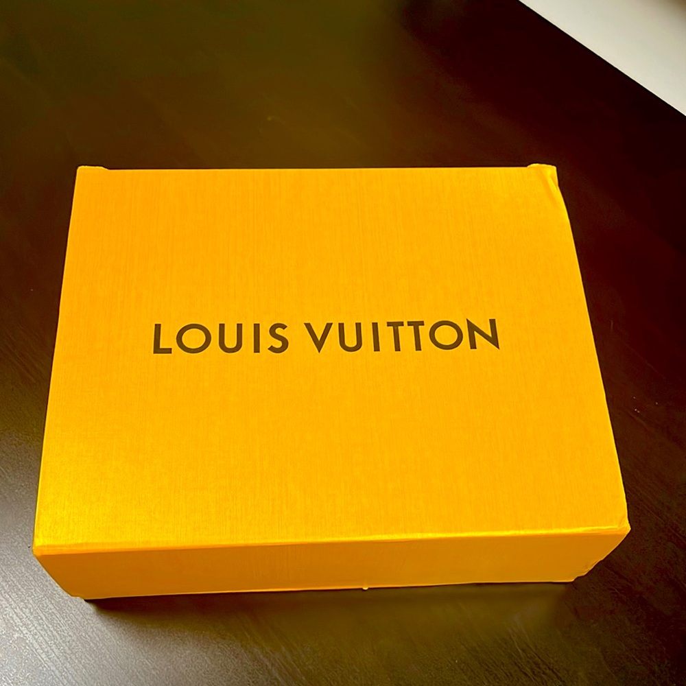 Cream Louis Vuitton Monogram Reverse coated canvas, with black handles.